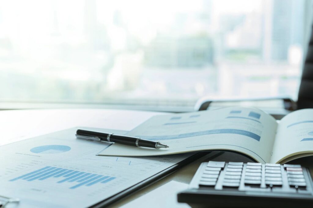 Financial reports, charts, and a calculator on an office desk